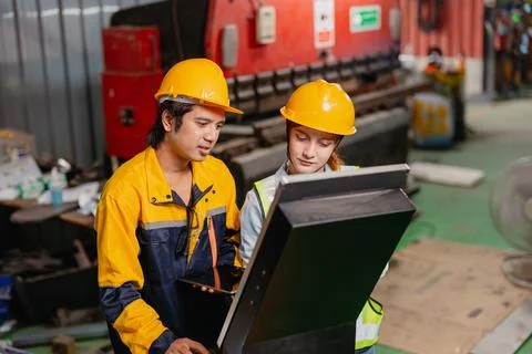 Engineers teamwork, Engineer man and woman team working together in metal w.. Foto stock