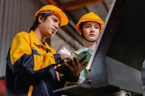 Engineers teamwork, Engineer man and woman team working together in metal w.. Stock Photos