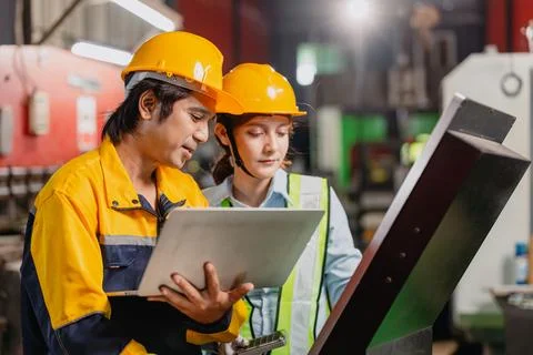 Engineers teamwork, Engineer man and woman team working together in metal w.. Stock Photos