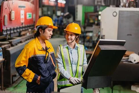Engineers teamwork, Engineer man and woman team working together in metal w.. Stock Photos
