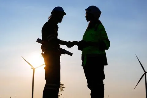 Engineers technicians working with teamwork at wind turbine field Stock Photos