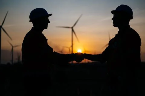 Engineers technicians working with teamwork at wind turbine field Stock Photos