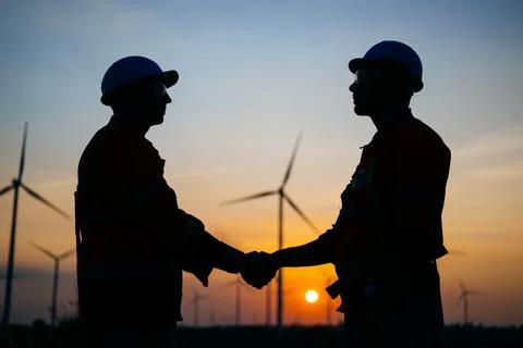 Engineers technicians working with teamwork at wind turbine field Stock Photos