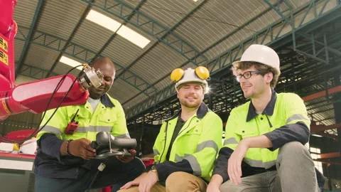 The Engineers test and control robotic arm in mechanical manufacturing factory. Stock Footage 227096238