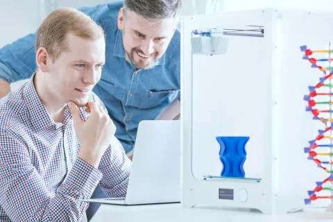 Engineers testing 3d printer Stock Photos