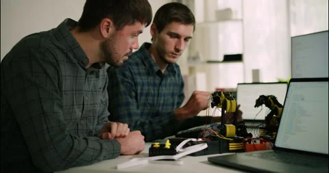Engineers Testing Robotic Arm with Code Interface. Stock Footage 306737075