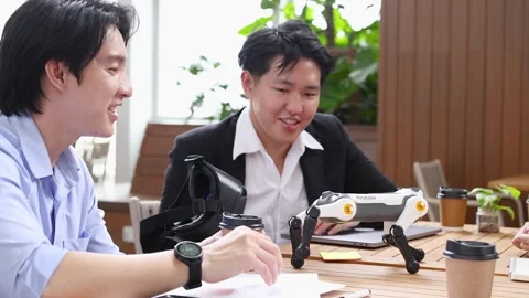 Engineers Testing Robotic Dog Prototype in Modern Bangkok Office Stock Footage 345487723