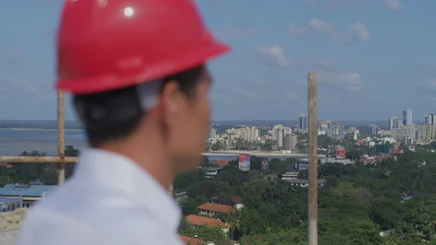 Engineers on the top of the construction site overlooking the city，Africa Stock Footage 132303352