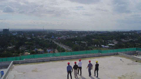 Engineers on the top of the construction site overlooking the city，Africa Stock Footage 132303873