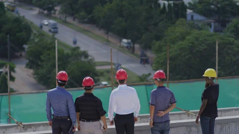 Engineers on the top of the construction site overlooking the city，Africa Stock Footage 132304337