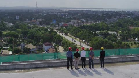 Engineers on the top of the construction site overlooking the city，Africa Stock Footage 132304985