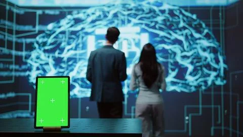 Engineers use green screen tablet and AI neural networks to look at data Stock Photos