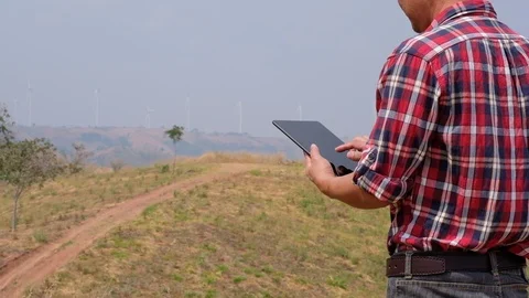 Engineers use the tablet to inspect wind turbines Stock-Footage 124779880