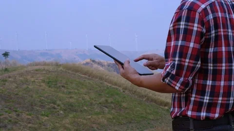 Engineers use the tablet to inspect wind turbines Stock Footage 124962828