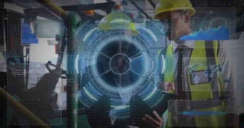 Engineers using holographic interface in plant, with tablet and yellow hard hats Stock Photos