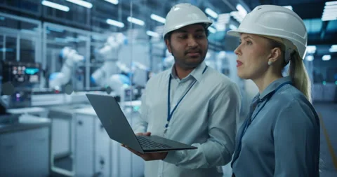 Engineers Using Laptop in Robotics Factory Stock Footage 319830110