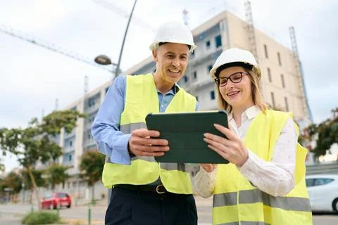 Engineers using tablet planning construction at site Stock Photos