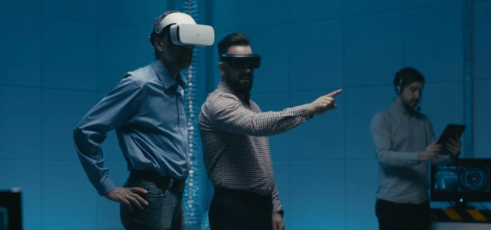 Engineers using VR glasses in workplace Foto stock