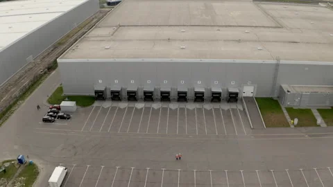 Engineers walk to check storage terminal with loading docks Stock Footage 202300926