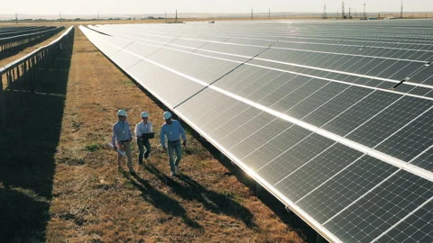 Engineers walking between rows of solar panels. Solar power plant workers, solar Stock Footage 142205212