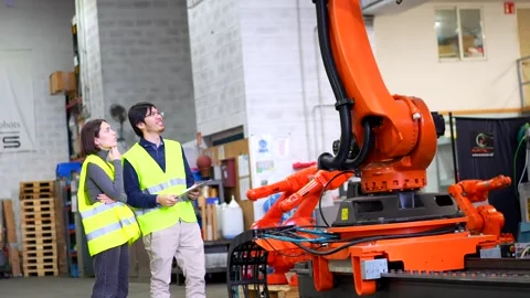 Engineers walking into the factory of robotic arms production Stock Footage 255734522