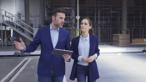 Engineers walking through factory talking and showing on tablet Stock Footage 108483459