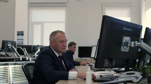 Engineers work on computers in control room of substation Stock Footage 154566687