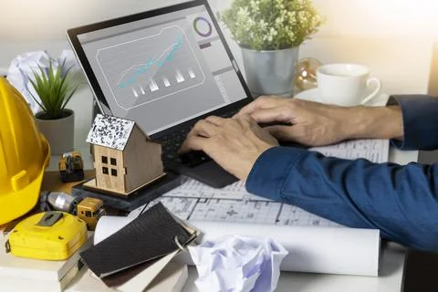 Engineers work on construction drawings and safety systems.,Building constr.. Ilustración de archivo