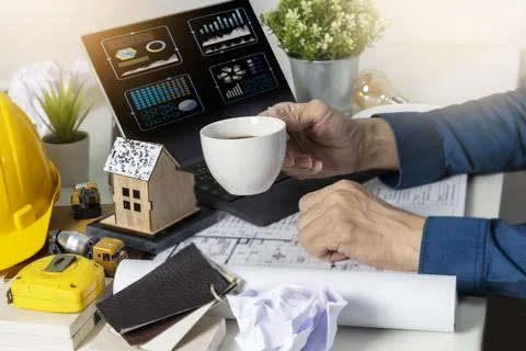 Engineers work on construction drawings and safety systems.,Building constr.. Stock Photos