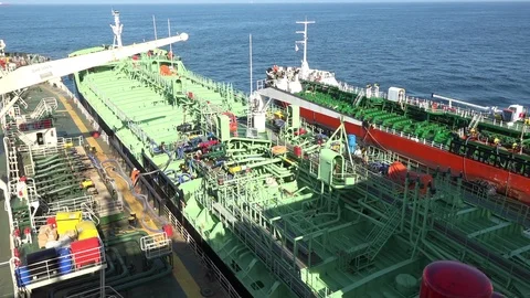 Engineers work on different oil tankers drifting on calm sea Stock Footage 113197249
