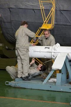 Engineers work on the emergency escape tower of the Soyuz TMA-09M spacecra... Stock Photos