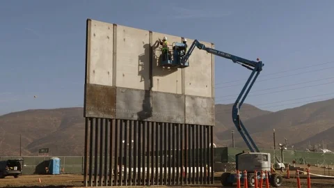 Engineers work on large wall being built from forklift Stock Footage 111849062