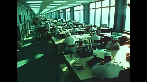 Engineers work in a scientific center at their desks building parts for a Stock Footage 157263277