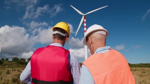 Engineers At Work Under Wind Turbines Stock Footage 277114655