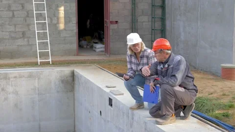 Engineers workers inspecting construction site of empty concrete pool Stock Footage 316264776