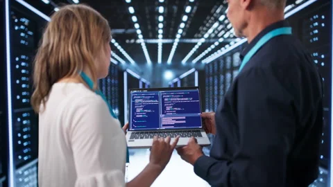 Engineers Working On Laptop Managing Servers Stock Footage 336367754
