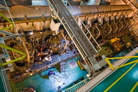 Engineers working on large engine of a ship Foto stock