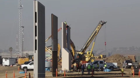 Engineers working on large walls in the desert Stock Footage 112128187