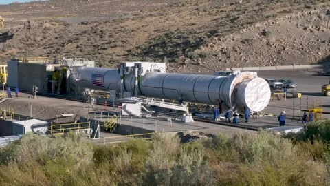 Engineers working near solid rocket booster prior to hot fire test Stock Footage 281724137