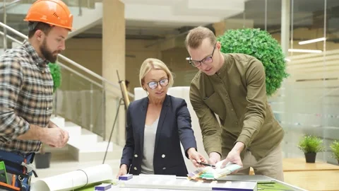 Engineers working in office with building 3d model Stock Footage 145356921