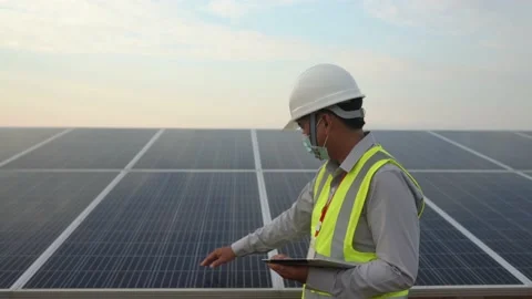 Engineers working to power solar panel renewable power plants in Thailand. Stock Footage 173365548