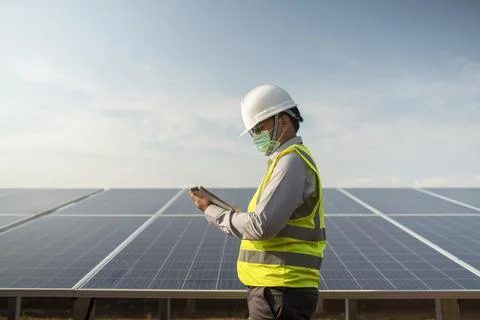 Engineers working to power solar panel renewable power plants in Thailand. Stock Photos