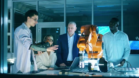 Engineers working on robot arm movements program. Innovation, modern technology Stock Footage 145601189