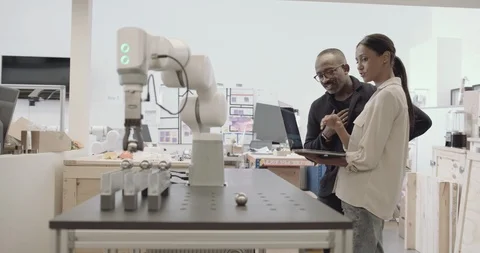 Engineers working on a robotic arm Stock Footage 121705986