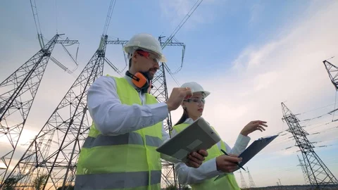 Engineers working with tablet near power substation, electrical substation Video stock 95130963
