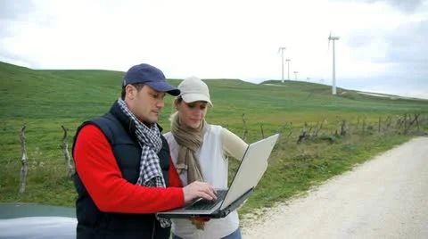 Engineers working by wind turbines field Stock Footage 14824882