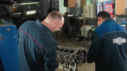 Engineers in Workshop: Assembling Engine and Using Smartphone Stock Footage 301250077