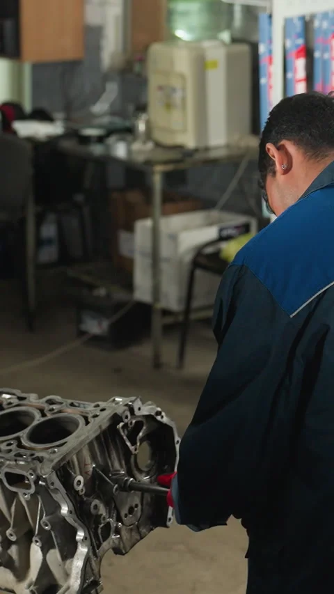 Engineers in Workshop: Assembling Engine and Using Smartphone Stock Footage 318246232