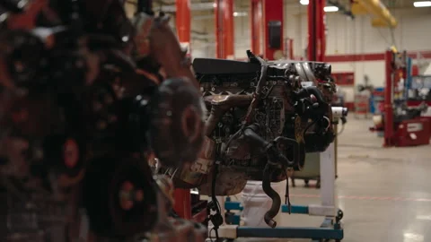 Engines ready for repair or assembly lined up in a large, modern car service Stock Footage 337200731
