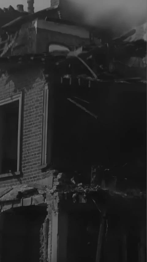 ENGLAND - 1940s - Firemen hose down enormous damaged buildings in war-torn Stock Footage 342256742